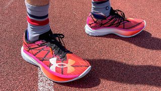 Person wearing the Under Armour Velociti Elite 2 running shoes on a track
