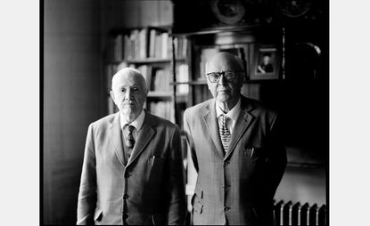 Artists Gilbert &amp; George in suits photographed side by side