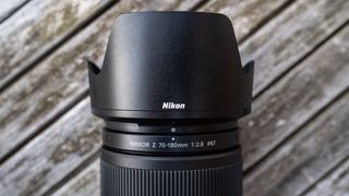 Nikkor Z 70-180mm f/2.8 attached to a Nikon Z 7II on a wooden outdoor table