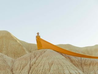 Veuve Clicquot Magnum Photos Emotions of the Sun: woman in yellow on rocks