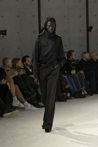 Model on Saint Laurent runway in hooded top