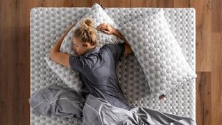 Blonde woman sleeps on the Layla Memory Foam Topper