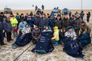 NASA astronaut Scott Kelly (right) and Russian cosmonauts Mikhail Kornienko and Sergey Volkov are seen in good spirits after their March 2, 2016 landing in a remote area near the town of Zhezkazgan, Kazakhstan (March 1 Eastern Time) to end a 340-day fligh