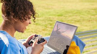 A woman playing games on a laptop