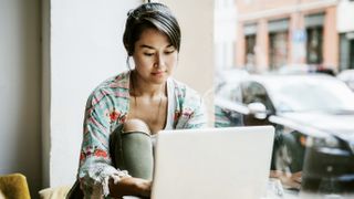 A student using her laptop in a coffee shop