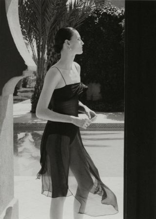 Model wears black against backdrop of Moroccan hotel