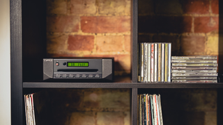 Cyrus CDi CD player with a shelf of CDs