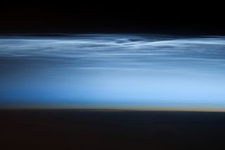 An photograph of night-shining clouds taken with a Nikon D3S digital camera using a 400 millimeter lens by an astronaut aboard the ISS on January 5, 2013. 