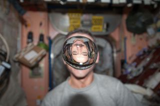 Hadfield Looks Through Water Droplet