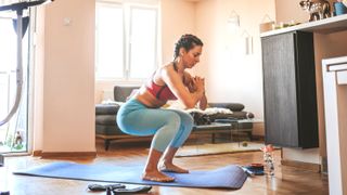 a photo of a woman performing a squat