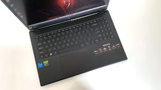 The keyboard deck of the Acer Nitro V 15 seen from above on a white table