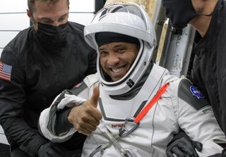 victor glover in a spacex spacesuit giving a thumbs-up