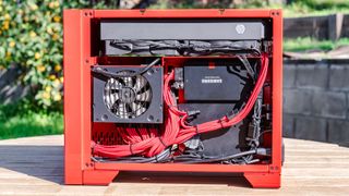 Maingear Turbo PC sitting on a table outside with its side panel off to showcase the internals