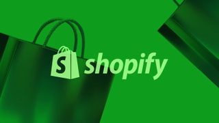 The Shopify Logo on a green background with two shopping bags at the edge of the frame