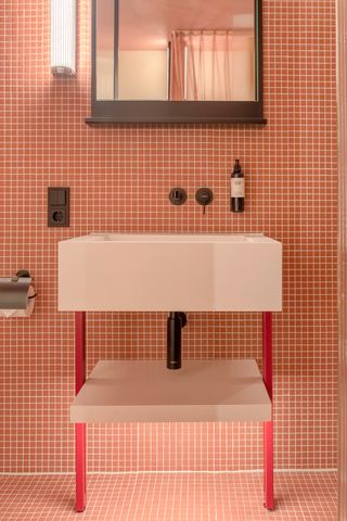 A pink-tiled bathroom