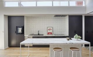 White marble dinning table in kitchen and brown wooden flooring.