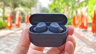 Jabra Elite 8 Active in black held in hand of reviewer