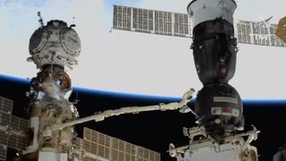 Russian flight controllers inspect the leaking Soyuz MS-22 spacecraft (right) with the European Robotic Arm on the International Space Station on Dec. 14, 2022.