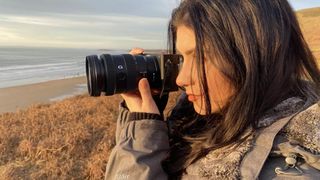 A photographer uses one of the best mirrorless cameras at the coast.