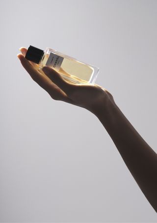 Chanel Comète eau de parfum held in the palm of a hand