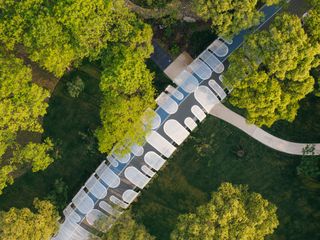 Emerald screen pergola by Wutopia Lab, aerial view of corridor through trees