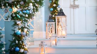 A porch which has been decorated for Christmas with lanterns and ornaments