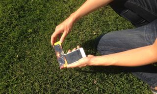 To protect your eyes and your device, photograph the sun using a solar filter, and use the front-facing camera so you can look down at the screen.