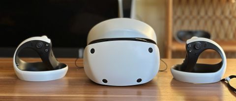 Sony PS VR2 and two Sense controllers sitting on a table.