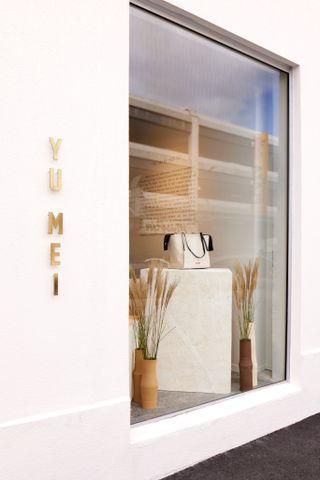 bag in window of auckland shop, white walls surrounding