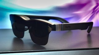 Photo of TCL RayNeo Air 2S AR smart glasses against a blue and purple vivid background