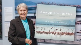 Former Canadian astronaut Roberta Bondar poses with her photos of the lesser flamingo, part of the AMASS (Avian Migration Aerial, Surface, Space) research project and her newly-released book, "Space for Birds: Patterns and Parallels of Beauty and Flight."