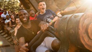 people on a roller coaster smiling