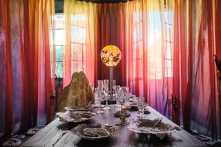 Tablescape with pink and yellow curtains in the background