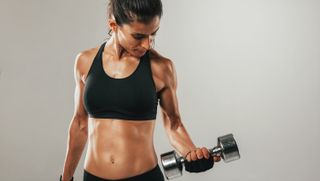 a photo of a woman curling a dumbbell