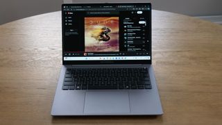 Asus ExpertBook P5 (P5405) open on a wooden table showing Dune soundtrack playing