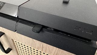 A Bluetooth adaptor inserted in a PS4 console.