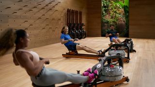 Apple Fitness Plus instructors leading a rowing class