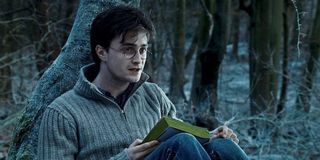 Harry Potter (Daniel Radcliffe) reads in Harry Potter and the Deathly Hallows - Part