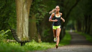 a photo of a girl running in a park