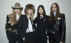 4 models wearing back formal suites and leather suites with headwear accessories