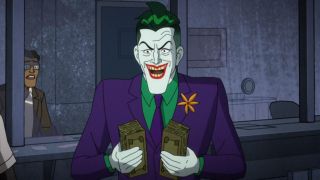 The Joker holding two stacks of cash in Harley Quinn