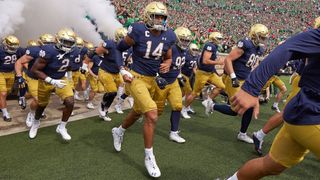 Notre Dame college football teams running out onto the field at the start of a game in 'Here Come the Irish'