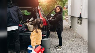A family unloads their electric car