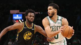 Jayson Tatum #0 of the Boston Celtics looks to pass the ball against Andrew Wiggins #22 of the Golden State Warriors