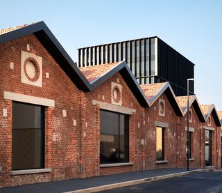 Exterior view of bricked offices with large glass windows at front