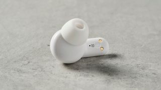 a single mixx streambuds mini ultra earbud rests on the table