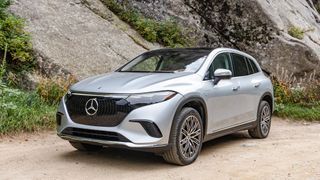 Mercedes EQS SUV parked outdoors in woods