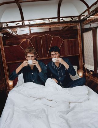 Men in pyjamas drink tea in bed aboard Orient Express