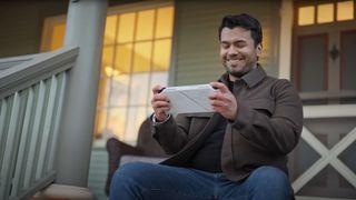 Man playing Asus ROG Ally outside.