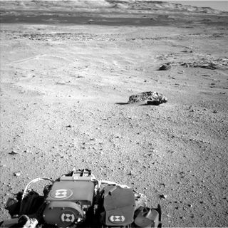 This photo by NASA's Curiosity rover on Mars shows three meteorites on the Martian surface, the rover's first space rock discoveries, found on May 25, 2014. The larger meteorite in the foreground is "Lebanon" (7 feet wide) and has a smaller companion, "Lebanon B". The third meteorite, seen behind and to the right of Lebanon, is also 7 feet wide.